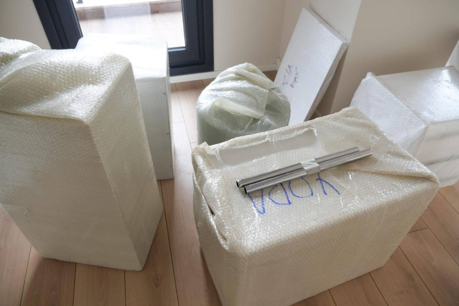 Unpacking Moving Boxes and Furniture in a New Home After a Recent Relocation Experience.